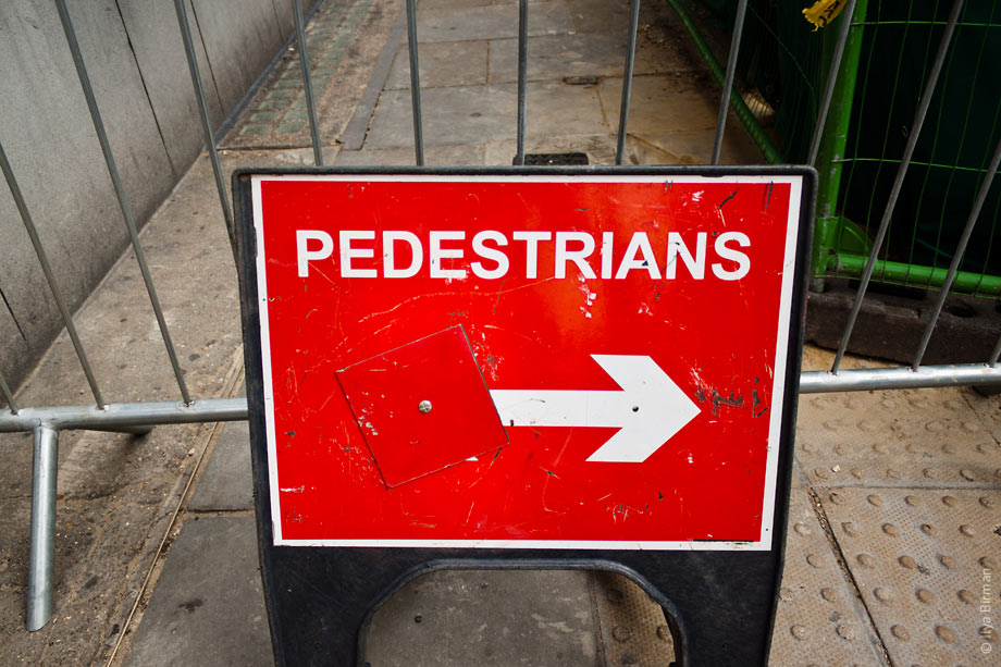Pedestrians are guided around a contruction site in London