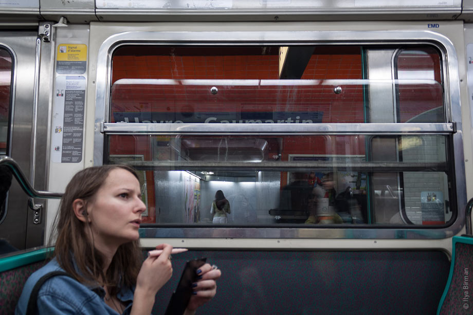 The girl takes a break in dolling herself up to make sure she will not miss her station