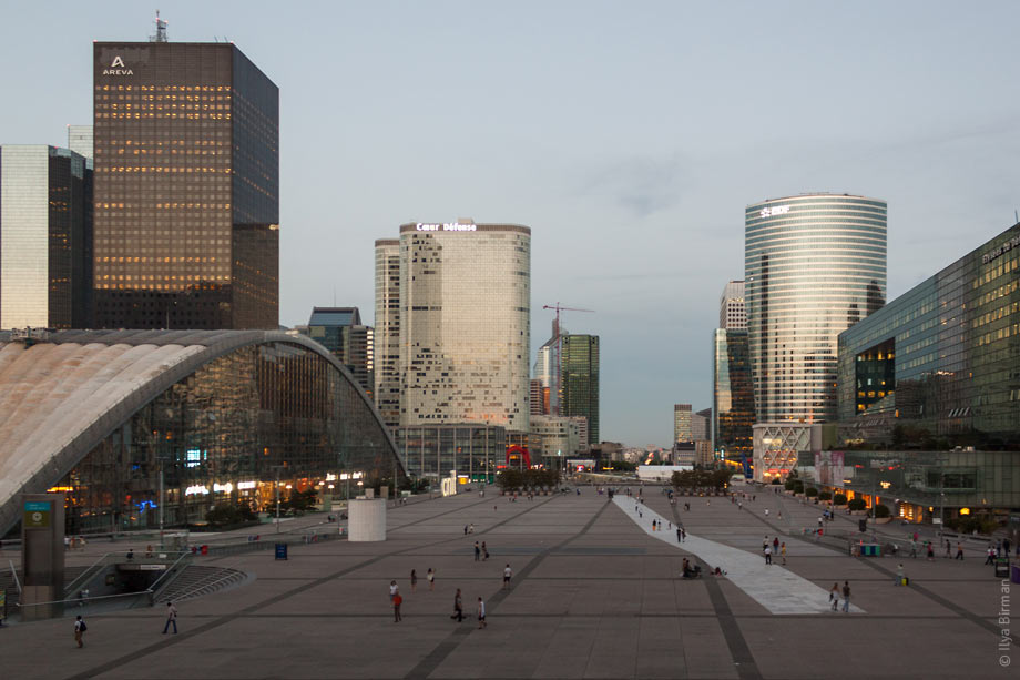 In front of the Grande Arche in Paris, there is a square with a huge white stripe